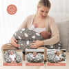 Mamá usando la almohada de lactancia Momcozy para amamantar o alimentar con mamadera cómodamente